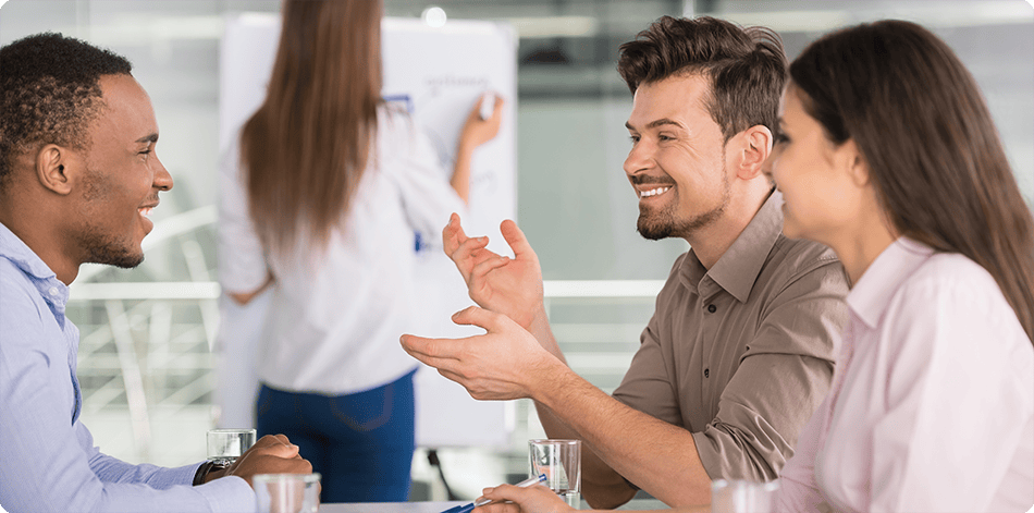 Professional men and women conversing in an office setting