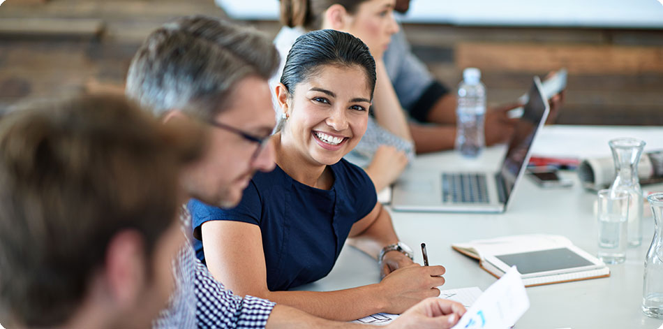 Woman smiling in an office meeting