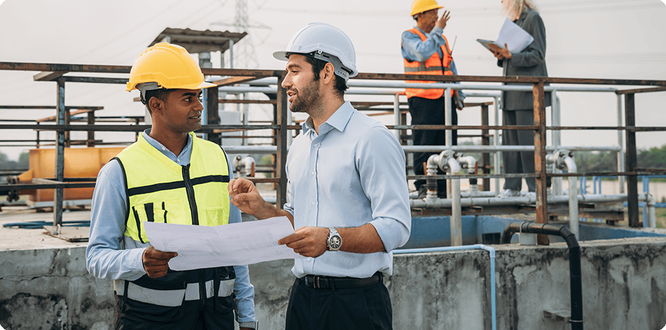 Two men discussing plans on a construction site